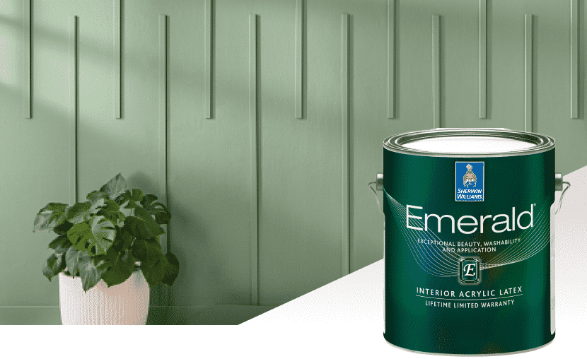 A can of Sherwin-Williams Emerald Interior Acrylic Latex paint in front of a green wall and potted plant.